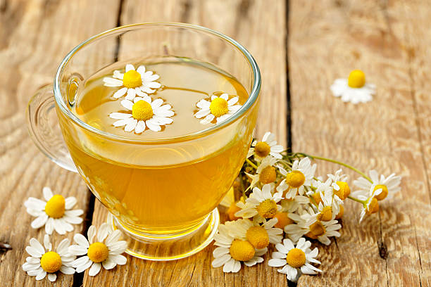 chamomile tea cup of chamomile tea with chamomile flowers chamomile photos stock pictures, royalty-free photos & images