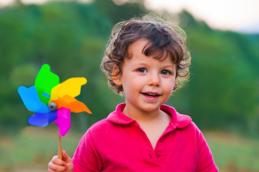 Happy child with colorful windmill