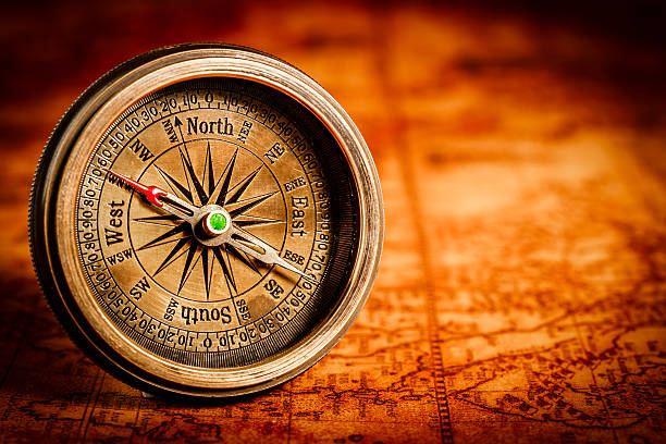 istock Vintage compass lies on an ancient world map. 487329532