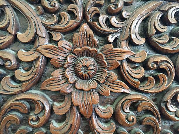 istock Carved wooden flowers ,background 487330156