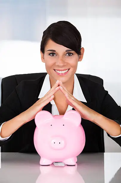 Photo of Businesswoman With Piggy Bank