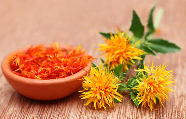 Safflower Safflower is a food additive on wooden surface flower stigma photos stock pictures, royalty-free photos & images