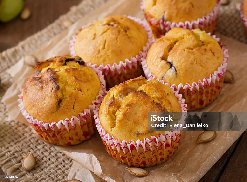 Appetizing and ruddy muffins with pumpkin and grapes 2015 Stock Photo