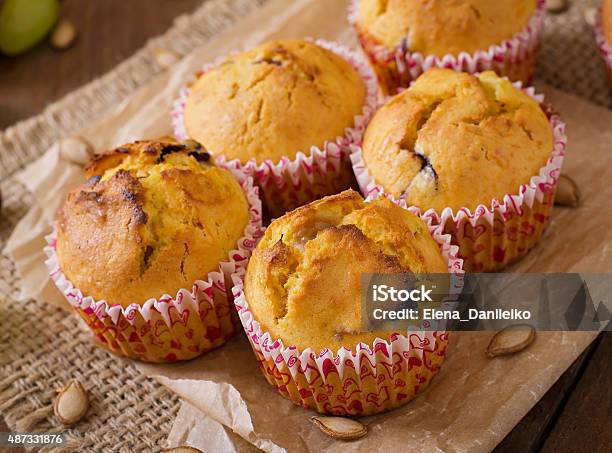 Appetizing And Ruddy Muffins With Pumpkin And Grapes Stock Photo - Download Image Now