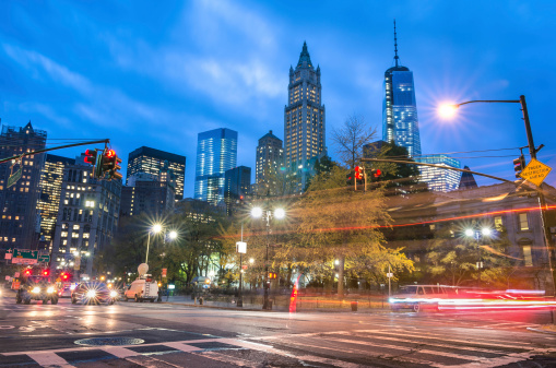 New York City traffic - Blurred lights at blue hour with Manhattan skyline in the background