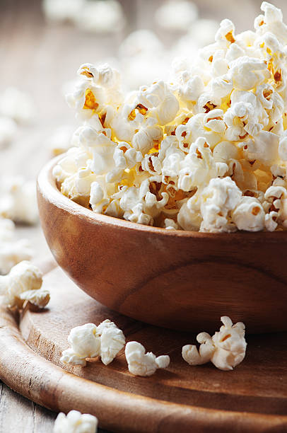 istock Salt popcorn on the wooden table 487332010