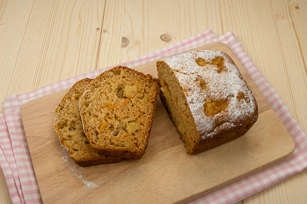 istock Fruit cake with two slices on a napkin and wooden 487335236