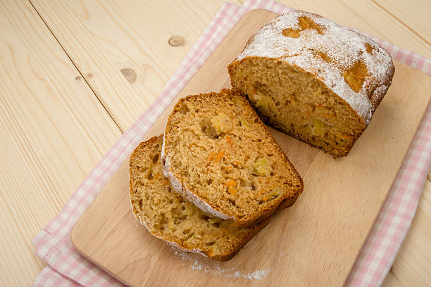 istock Fruit cake with two slices on light wooden 487335240