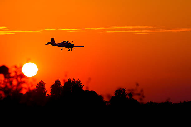 istock small airplane silhouette against backdrop of setting sun 487345562