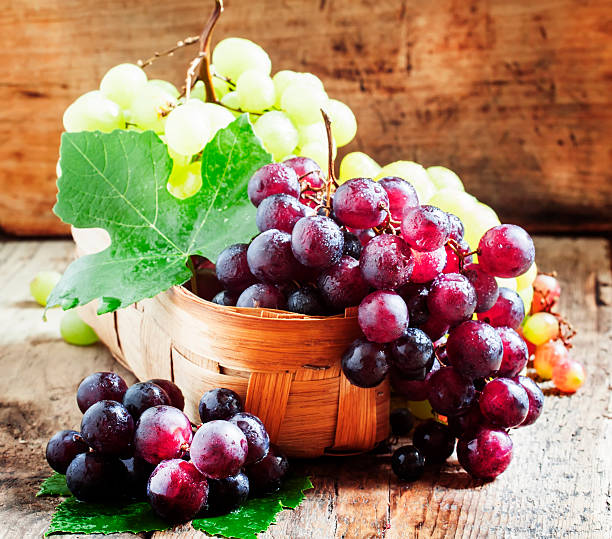 istock Purple round ripe grapes in a wicker basket 487355334