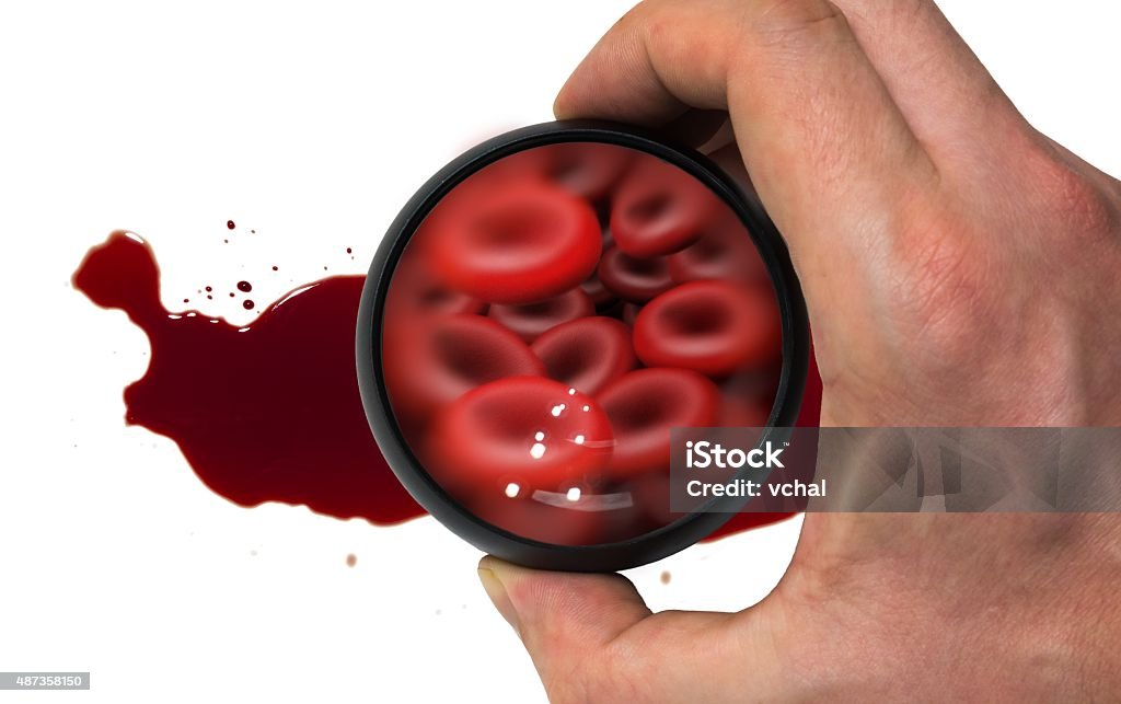 Doctor's hand examining red blood cells with magnifier in blood Doctor's hand examining red blood cells with magnifier in blood splash  2015 Stock Photo