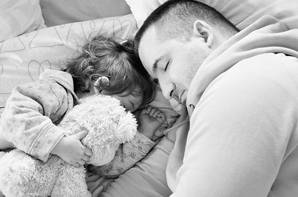 istock Father and Baby Girl Sleeping 487358733
