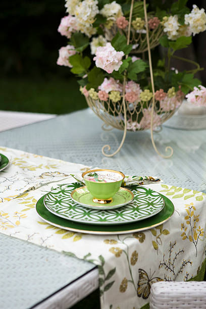 Garden Table with Green Cup and Plate stock photo