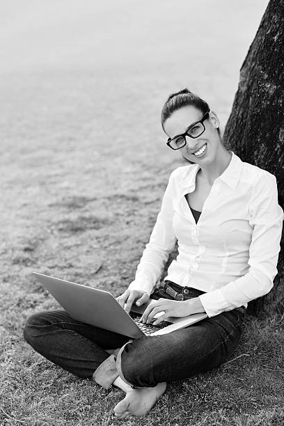 istock woman with laptop in park 487359199