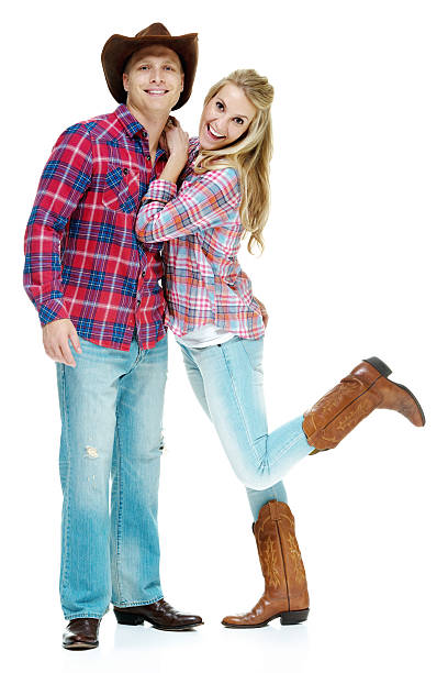 Happy cowboy couple standing together