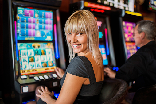 Woman Gambling On Slot Machines Stock Photo - Download Image Now - Slot  Machine, Women, Casino - iStock