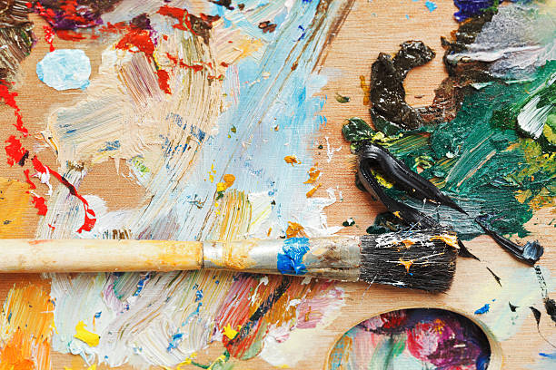 istock paint brush on wooden artistic pallette 487361913