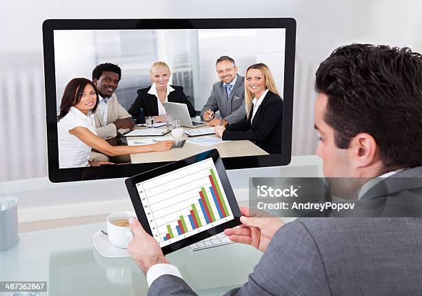 Businessman In Conference Analyzing Graph Stock Photo - Download Image Now - Blue-collar Worker, Web Conference, Adult