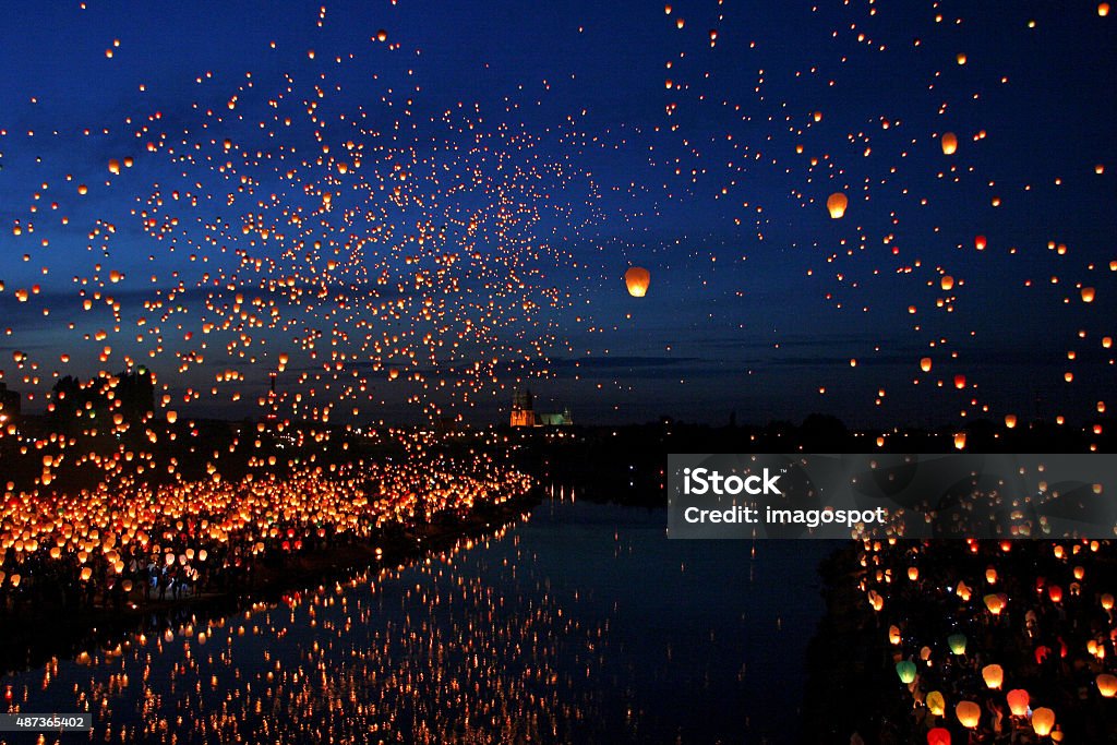 Lots of Paper Fly Lanterns next to the River A large collection of flying chinese lanterns next to the River Lantern Stock Photo