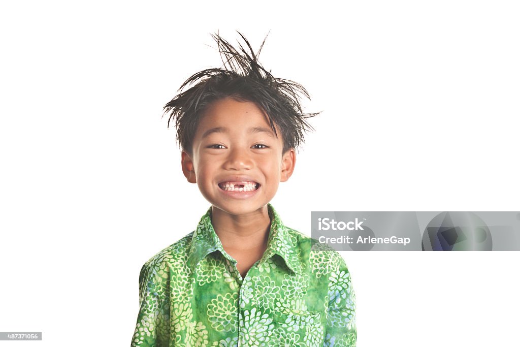 Smiling messy hair child with missing front teeth This adorable 7 year old flashes a bright smile for the camera, revealing two front missing teeth.  Wearing a green Hawaiian shirt, this child encompasses the Spirit of Aloha through his happy and positive facial expression   Image isolated on white Child Stock Photo