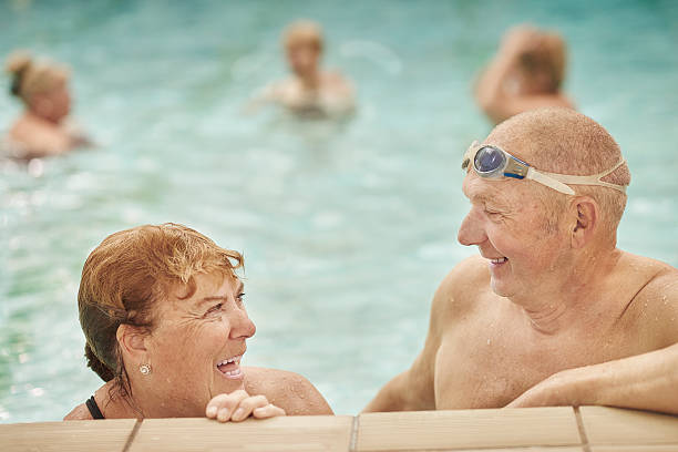 istock retired couple having fun at the swimming pool 487371966