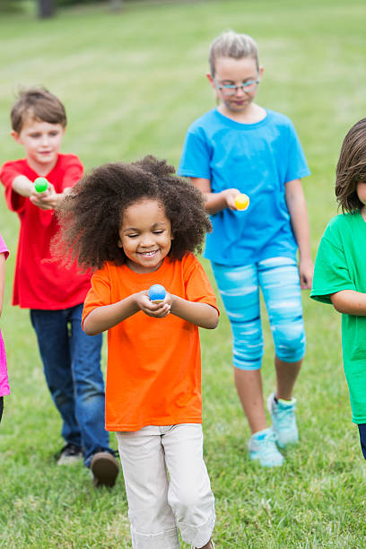 istock Multiracial group of children in an egg spoon race 487374246