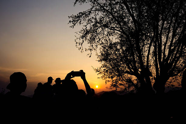 istock Silhouette of travelers with camera during sunset 487376150