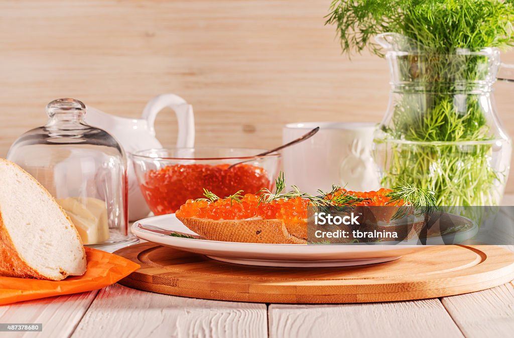 Sandwich with red caviar, butter and dill. Sandwich with red caviar, butter and dill on a white background 2015 Stock Photo