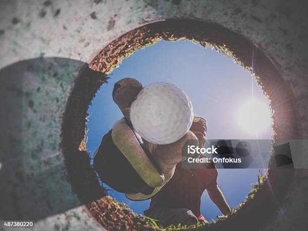 Point Of View Golf Player And Ball From Inside Hole Stock Photo - Download Image Now