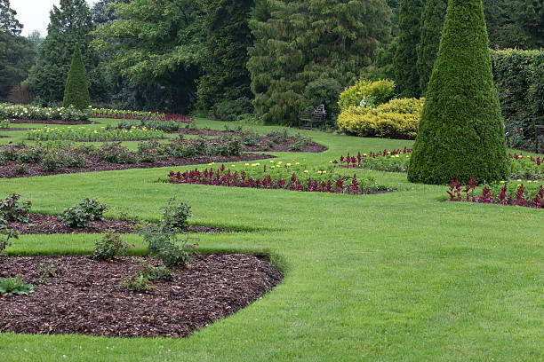 istock Garden Scene with Flowerbeds and Topiary 487380312