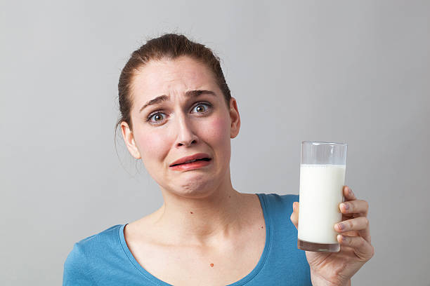 istock phobic 20s girl horrified at dieting with white protein liquids 487383152
