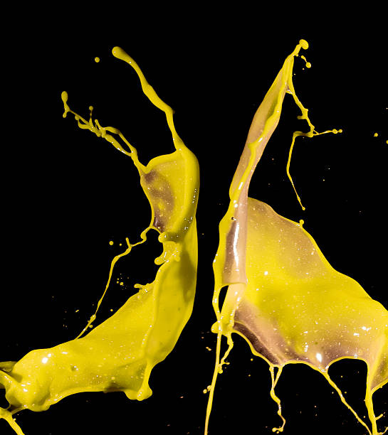 istock splashes of yellow paint isolated on black background 487383258