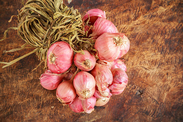 istock red onions on  wooden background 487384090