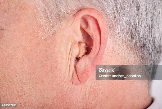 Senior Wearing Cic Hearing Aid Stock Photo - Download Image Now - AIDS, Adult, Audiologist
