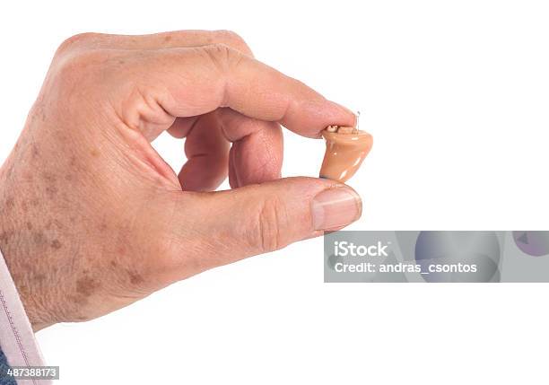 Cic Hearing Aid Between Fingers Stock Photo - Download Image Now - AIDS, Adult, Audiologist