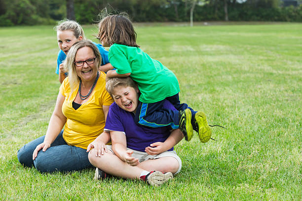 istock Mother and three children playing in the park 487391290