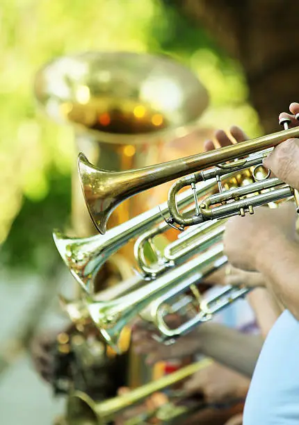 Brass section of an orchestra wit visible trumpets an tuba in a row - shallow focus.
