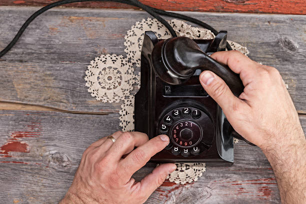 istock Man dialing out on an old rotary telephone 487392869