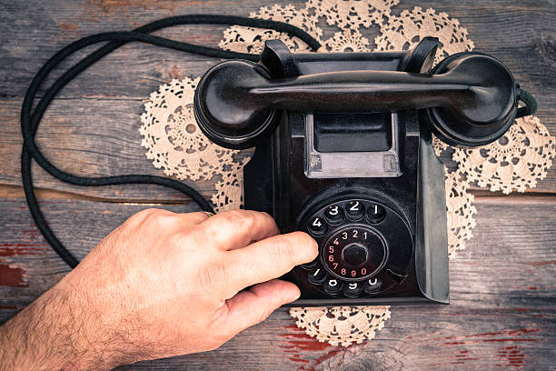 istock Man making a call on a rotary telephone 487393855