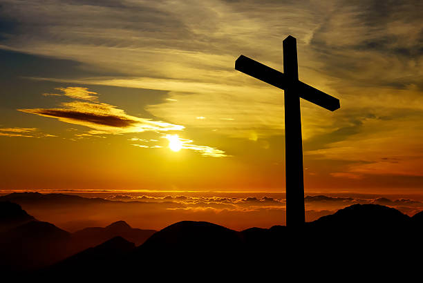 istock Christian cross on sunset background 487397578