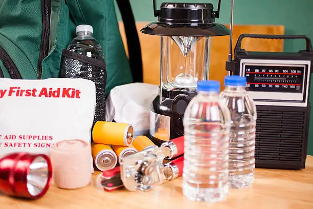Photo of Emergency preparedness natural disaster supplies. Water, flashlight, lantern, batteries.