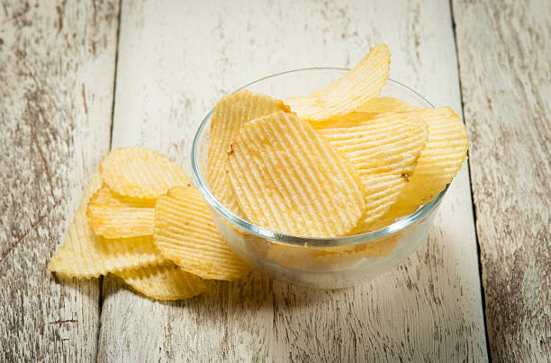 istock potato chips in a wooden bowl 487398506