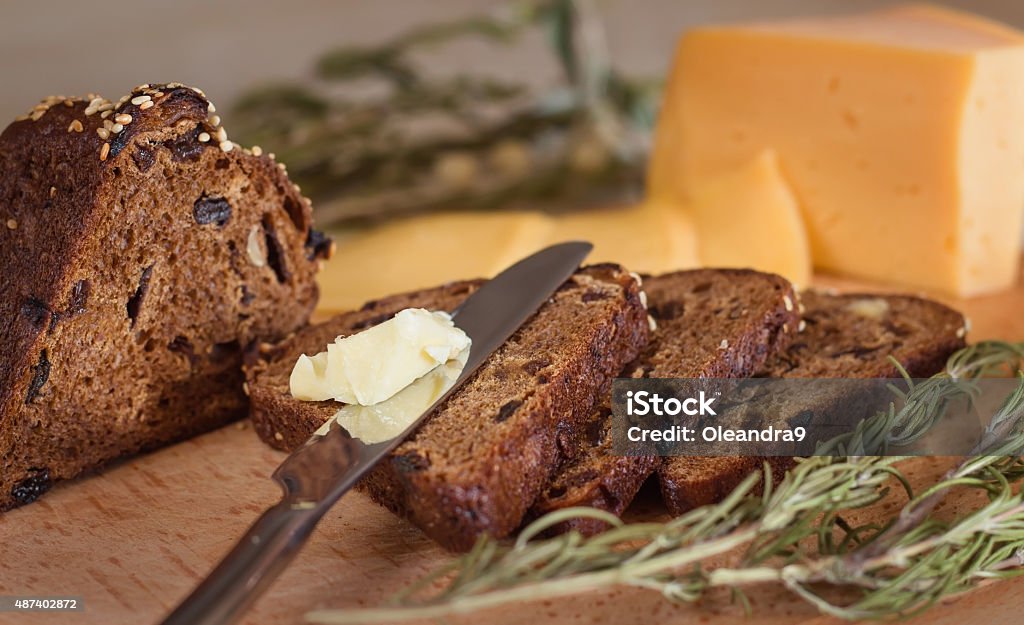 dark bread with butter and cheese breakfast. Lunch. Dark bread with butter and cheese on wood surface.  Backgrounds Stock Photo