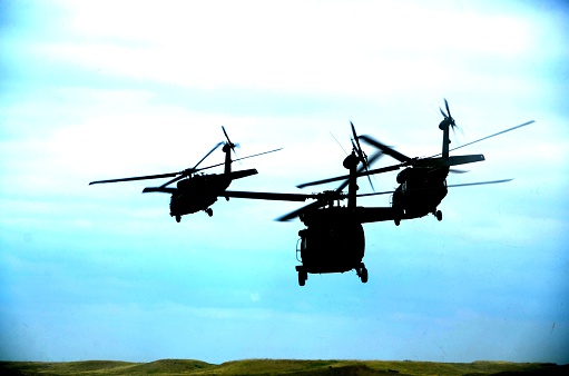Ft. Carson, Co, USA - June 7, 2014: The Colorado National Guard in partnership with Fort Carson conducted a (CALFEX) combined-arms live-fire exercise and public demonstration at Fort Carson. Blackhawk Helicopters flying away. 