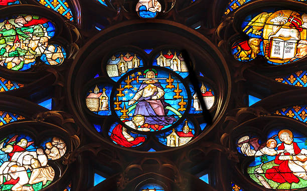 Jesus Sword Rose Window Stained Glass Sainte Chapelle Paris France Paris, France - June 1, 2015: Jesus Christ With Sword Rose Window Stained Glass Saint Chapelle Paris France.  Saint King Louis 9th created Sainte Chappel in 1248 to house Christian relics, including Christ's Crown of Thorns.  Stained Glass created in the 13th Century and shows various biblical stories along wtih stories from 1200s. sainte chapelle stock pictures, royalty-free photos & images