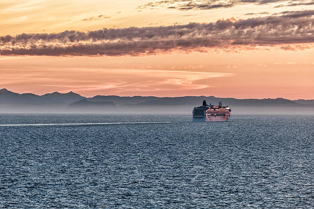 Seattle, USA - August 22, 2015: Norwegian Cruise Line ship Norwegian Jewel sails through the San Juan Islands into a hazy sunset.