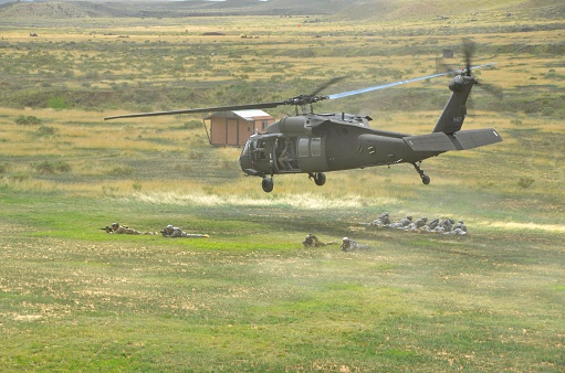 Ft. Carson, CO, USA - June 7, 2014: The Colorado National Guard in partnership with Fort Carson conducted a (CALFEX) combined-arms live-fire exercise and public demonstration at Fort Carson. Soldiers in a defensive position after deploying from a Blackhawk helicopter. 