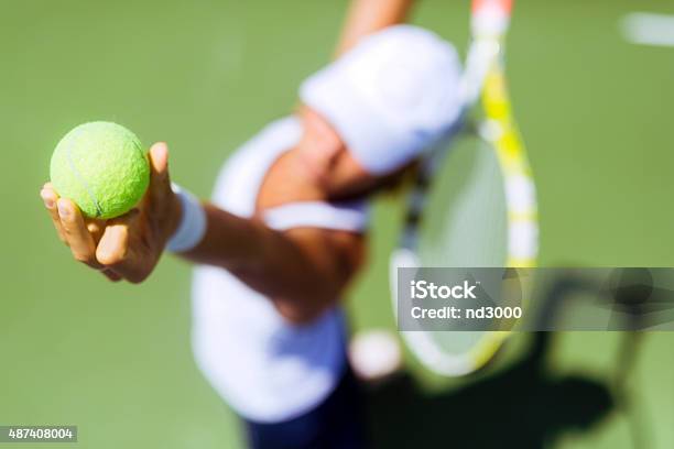 Beautiful Female Tennis Player Serving Stock Photo - Download Image Now - Tennis, Serving - Sport, Women