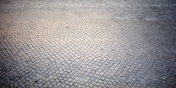 Top view on texture background of straight flat stony brick grey paving stone street road outdoor copyspace, horizontal picture