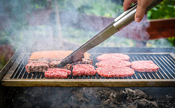 istock Grilling Meat on barbecue grill with coal. 487408812